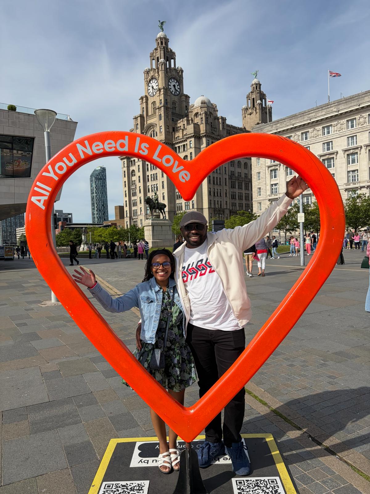 Leo and Njoki inside the ‘All You Need Is Love’ heart sculpture in Liverpool